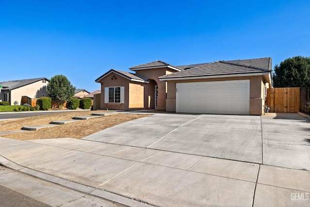 6522 Bangor Pl, Bakersfield, CA 93313 - view of front facade featuring an attached garage, stucco siding, driveway, and a tiled roof