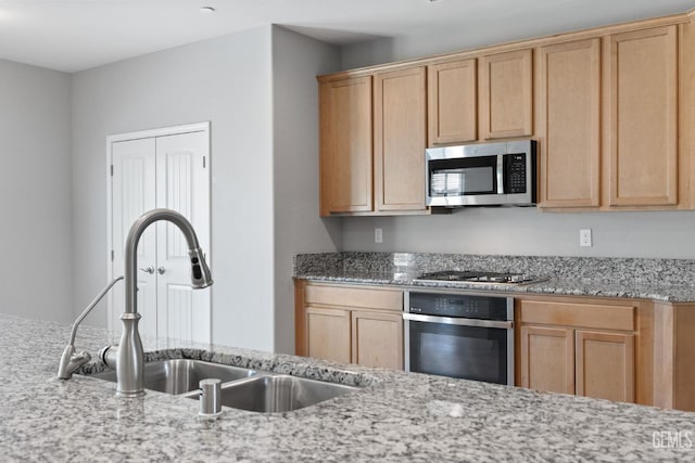 6522 Bangor Pl, Bakersfield, CA 93313 - kitchen featuring stainless steel appliances, light stone countertops, and light brown cabinets