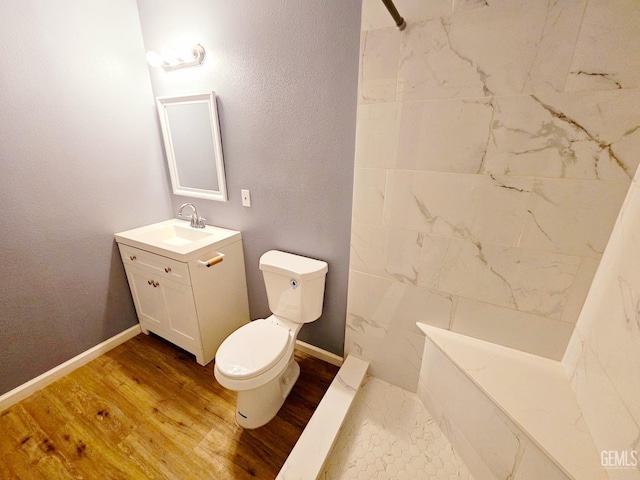 bathroom with wood-type flooring, vanity, and toilet