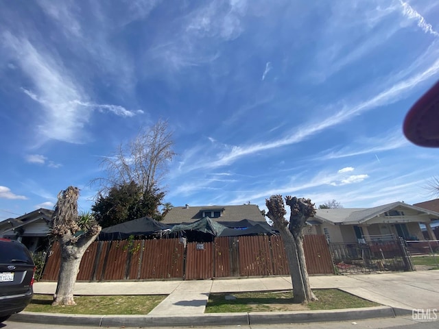 706 L St, Bakersfield, CA 93304 - view of front facade with a fenced front yard, a residential view, and a gate
