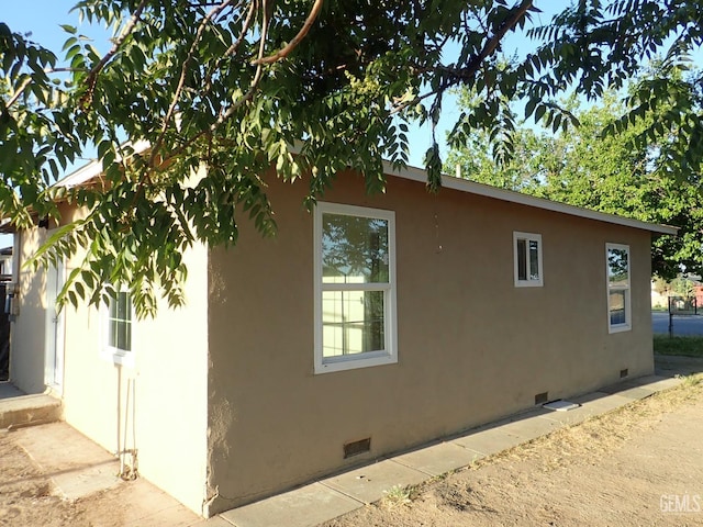 view of home's exterior featuring crawl space and stucco siding