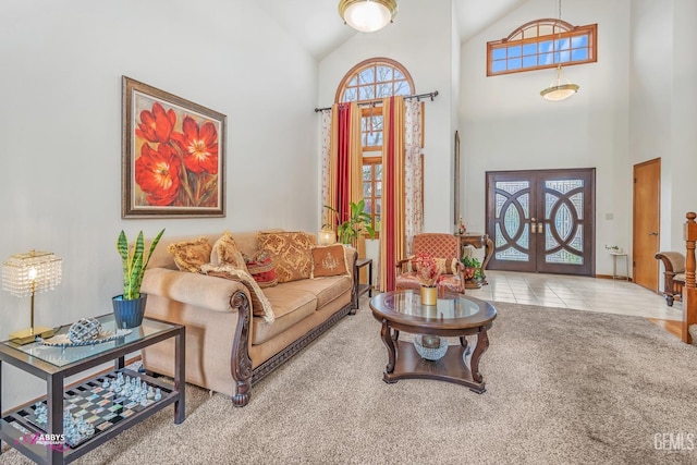 carpeted living area featuring tile patterned floors, french doors, and high vaulted ceiling