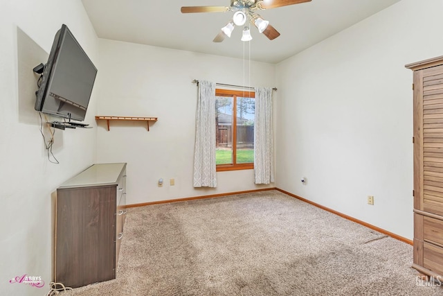 unfurnished living room with baseboards, a ceiling fan, and carpet flooring