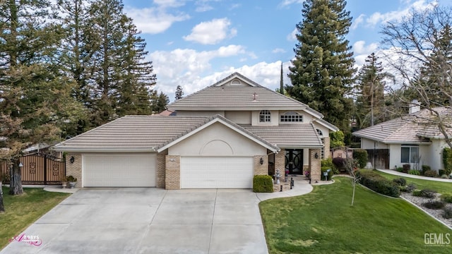 view of front of home with brick siding, fence, driveway, an attached garage, and a gate