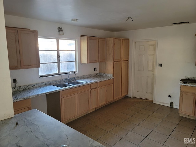 kitchen with visible vents, light brown cabinetry, a sink, light tile patterned floors, and light stone countertops