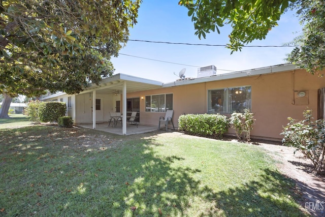1112 Pebble Beach Dr, Bakersfield, CA 93309 - back of property with a yard, a patio, stucco siding, and ceiling fan