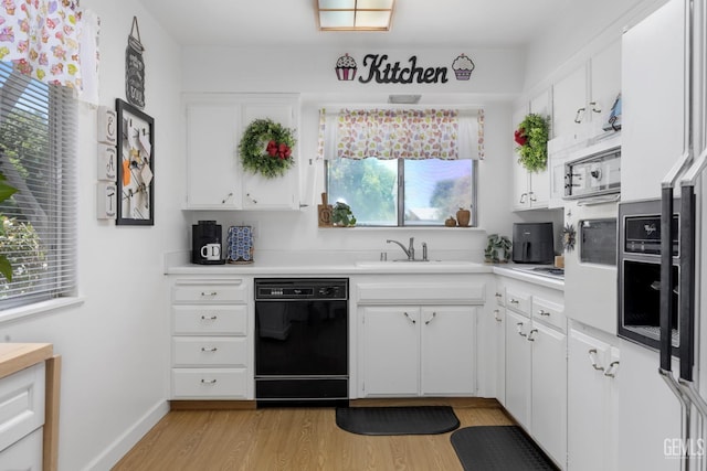 1112 Pebble Beach Dr, Bakersfield, CA 93309 - kitchen featuring dishwasher, light wood-type flooring, light countertops, white cabinets, and oven