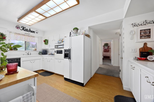 1112 Pebble Beach Dr, Bakersfield, CA 93309 - kitchen with white appliances, light wood-type flooring, light countertops, and white cabinetry