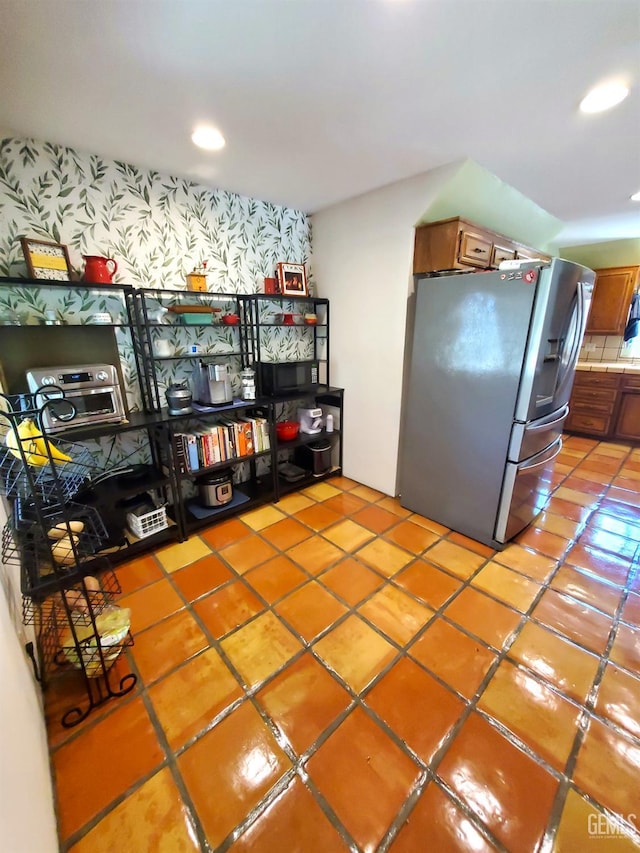 6333 Crestmore St, Bakersfield, CA 93308 - kitchen featuring stainless steel fridge with ice dispenser, light tile patterned floors, brown cabinets, and recessed lighting