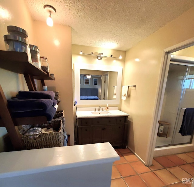 6333 Crestmore St, Bakersfield, CA 93308 - ensuite bathroom featuring tile patterned flooring, vanity, a textured ceiling, and a stall shower
