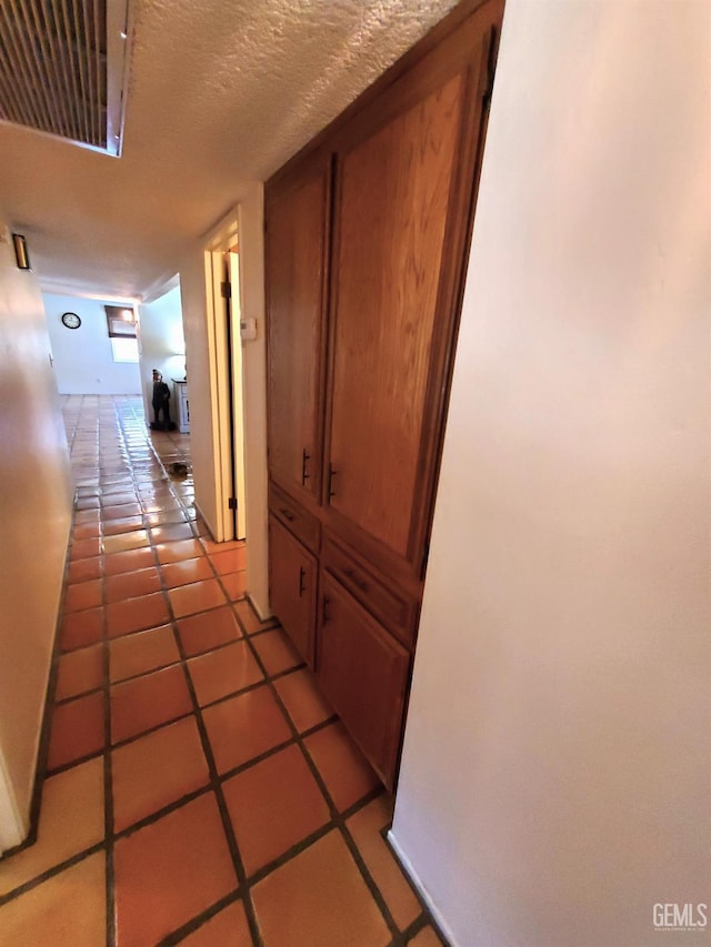 6333 Crestmore St, Bakersfield, CA 93308 - hall featuring light tile patterned floors, baseboards, and a textured ceiling