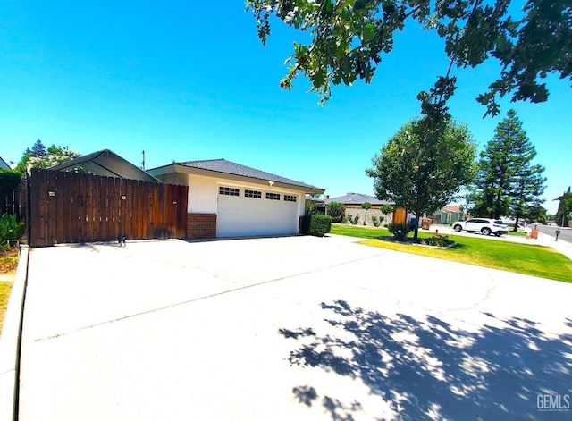 6333 Crestmore St, Bakersfield, CA 93308 - view of front of home featuring brick siding, driveway, and a garage