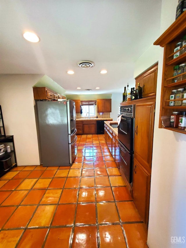 6333 Crestmore St, Bakersfield, CA 93308 - kitchen with black appliances, light countertops, brown cabinetry, recessed lighting, and light tile patterned floors