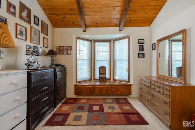 interior space featuring vaulted ceiling with beams, wooden ceiling, and light carpet