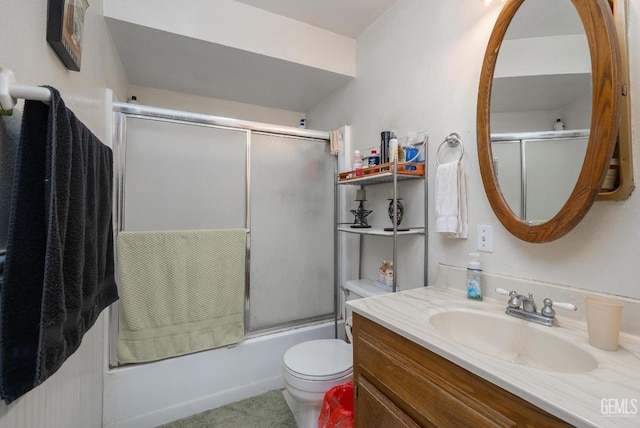 full bathroom featuring shower / bath combination with glass door, vanity, and toilet