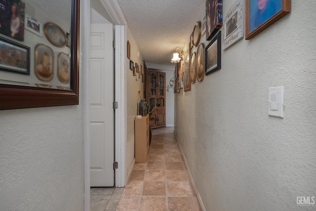 hallway featuring a textured ceiling