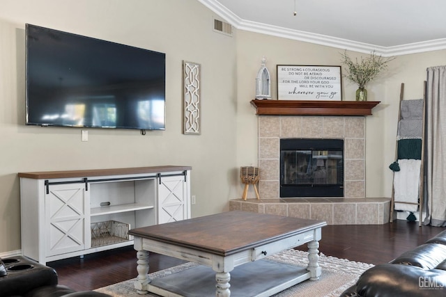 living room with crown molding, a fireplace, and dark hardwood / wood-style flooring