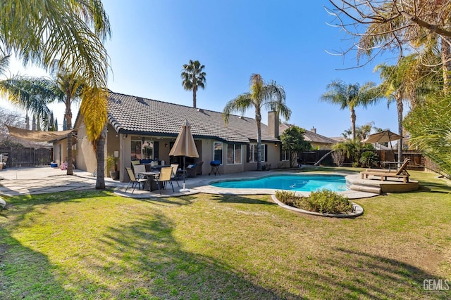 view of pool with a lawn and a patio area