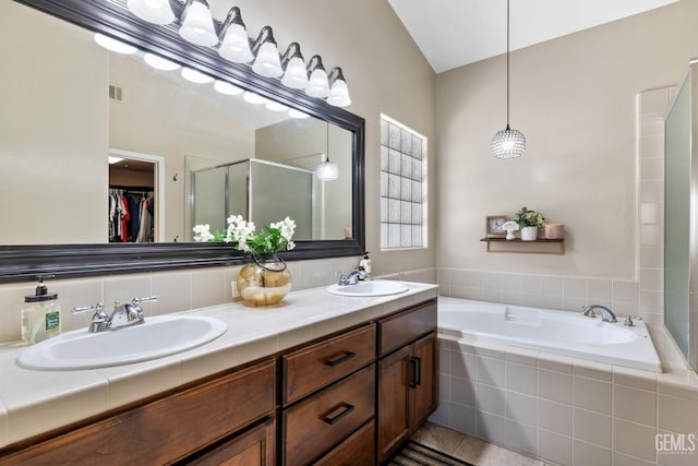 bathroom with independent shower and bath and vanity