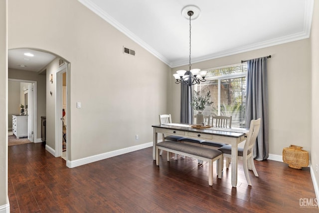 dining space with lofted ceiling, crown molding, dark hardwood / wood-style floors, and a chandelier