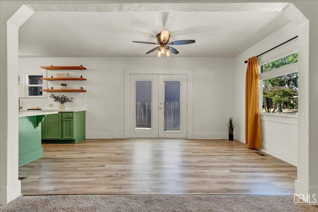 930 S Roosevelt Ave, Fresno, CA 93728 - unfurnished living room with a ceiling fan, french doors, light wood-style flooring, and baseboards