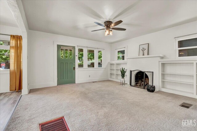 930 S Roosevelt Ave, Fresno, CA 93728 - unfurnished living room featuring ceiling fan, baseboards, a brick fireplace, and carpet floors
