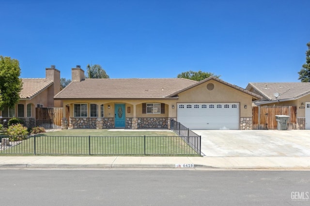 6418 Abby Rose Ave, Bakersfield, CA 93308 - ranch-style home featuring stucco siding, stone siding, an attached garage, and driveway
