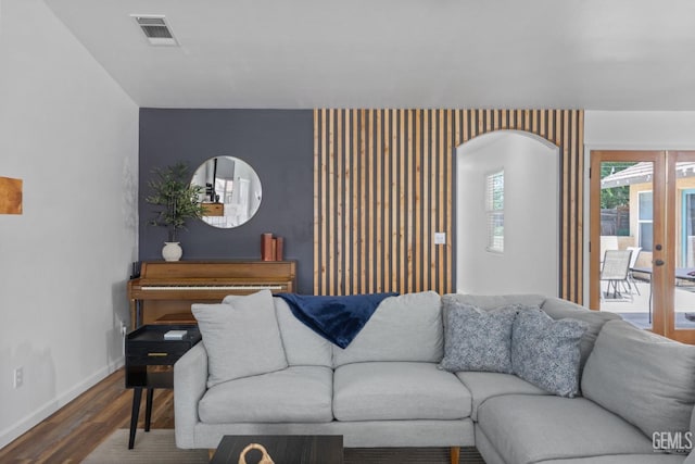 6418 Abby Rose Ave, Bakersfield, CA 93308 - living room with wood finished floors, baseboards, arched walkways, french doors, and an accent wall