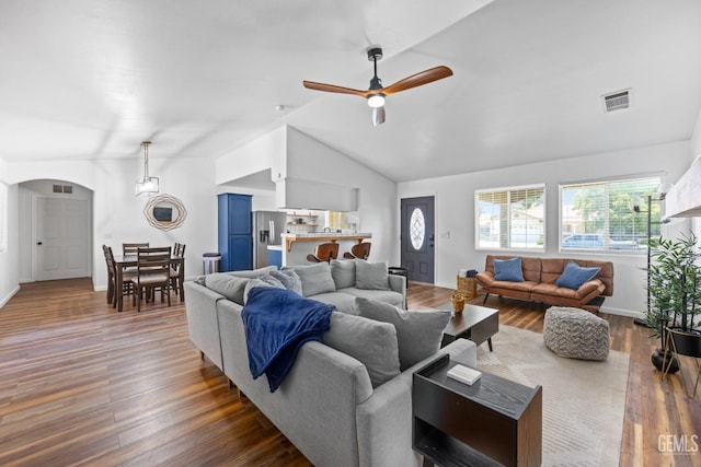 6418 Abby Rose Ave, Bakersfield, CA 93308 - living area featuring a ceiling fan, lofted ceiling, dark wood-style flooring, arched walkways, and baseboards
