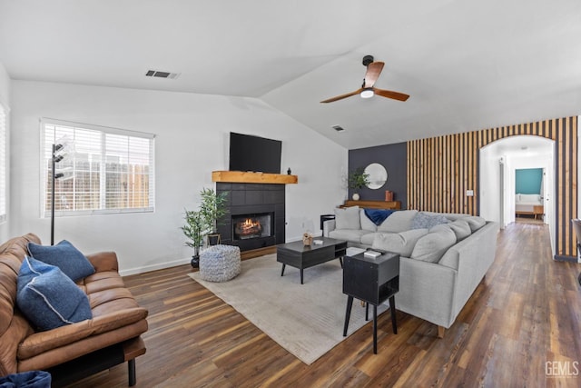 6418 Abby Rose Ave, Bakersfield, CA 93308 - living room with arched walkways, a ceiling fan, dark wood finished floors, lofted ceiling, and a fireplace
