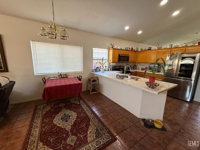 3910 Mariana Way, Bakersfield, CA 93311 - kitchen with stainless steel appliances, a peninsula, light countertops, a chandelier, and recessed lighting