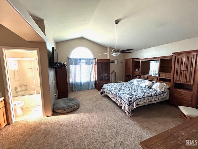 carpeted bedroom featuring ceiling fan, lofted ceiling, and ensuite bathroom