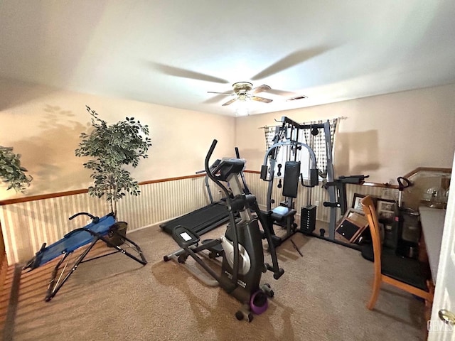 workout area with ceiling fan and carpet flooring