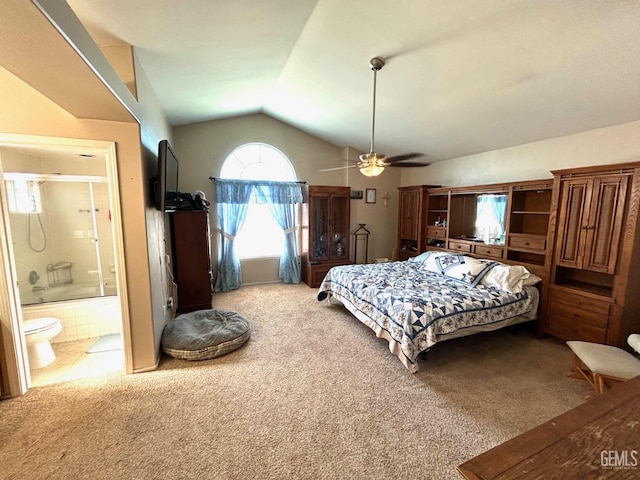 bedroom with ceiling fan, light colored carpet, connected bathroom, and vaulted ceiling