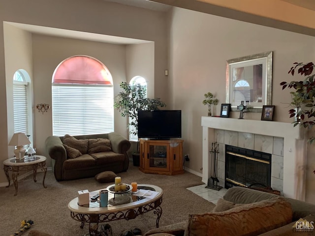 living room with light carpet and a tile fireplace