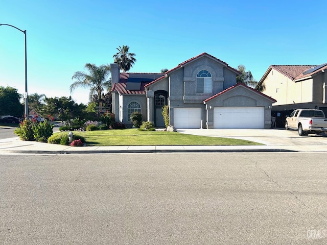 view of front of home with a garage and a front yard