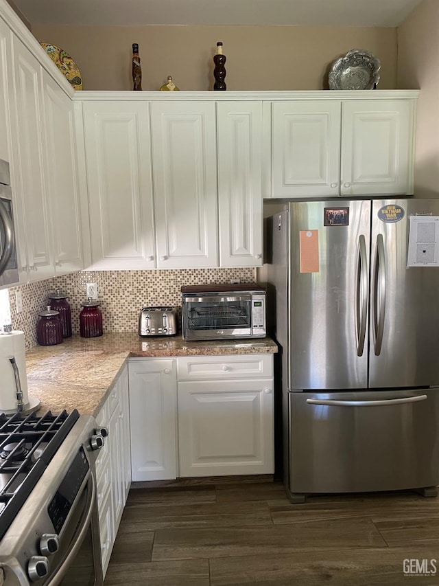 10011 Rosebud Ave, Bakersfield, CA 93311 - kitchen featuring stainless steel appliances, white cabinetry, decorative backsplash, dark wood finished floors, and light stone counters