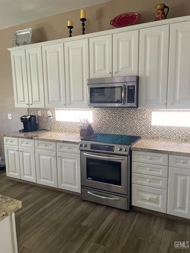 10011 Rosebud Ave, Bakersfield, CA 93311 - kitchen with stainless steel appliances, white cabinets, dark wood-style flooring, and backsplash