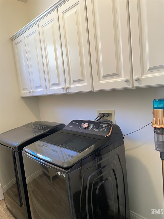 10011 Rosebud Ave, Bakersfield, CA 93311 - laundry area with washing machine and dryer, cabinet space, wood finished floors, and baseboards