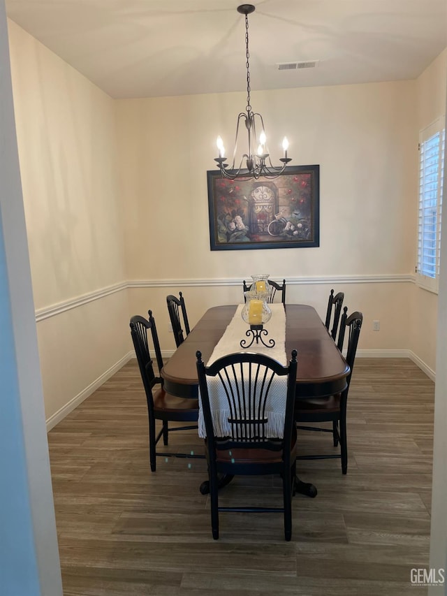 10011 Rosebud Ave, Bakersfield, CA 93311 - dining area featuring a chandelier, wood finished floors, and baseboards