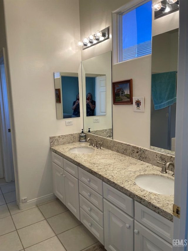 10011 Rosebud Ave, Bakersfield, CA 93311 - bathroom with tile patterned flooring, double vanity, and baseboards