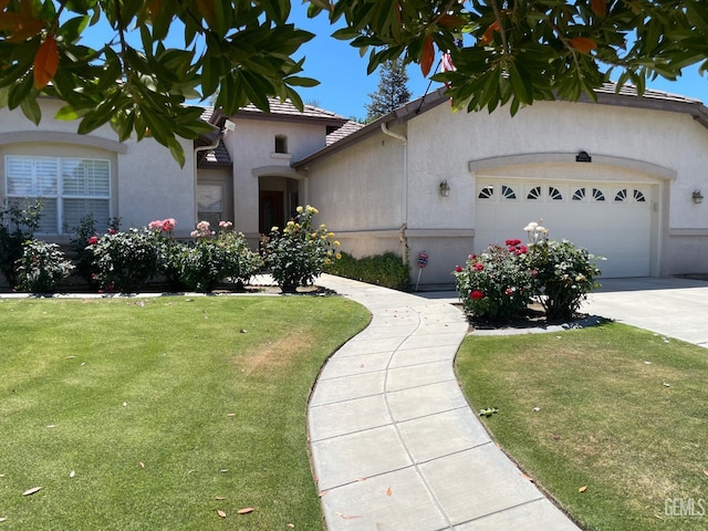 10011 Rosebud Ave, Bakersfield, CA 93311 - view of front of house with a garage, stucco siding, a front lawn, and driveway
