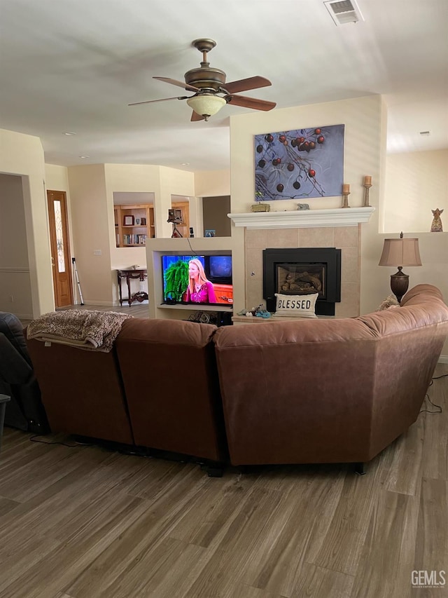 10011 Rosebud Ave, Bakersfield, CA 93311 - living room with a tiled fireplace, wood finished floors, and a ceiling fan