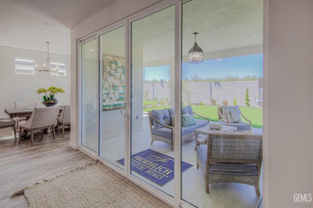 11022 Irontooth Ave, Bakersfield, CA 93311 - doorway to outside with wood finished floors and a chandelier