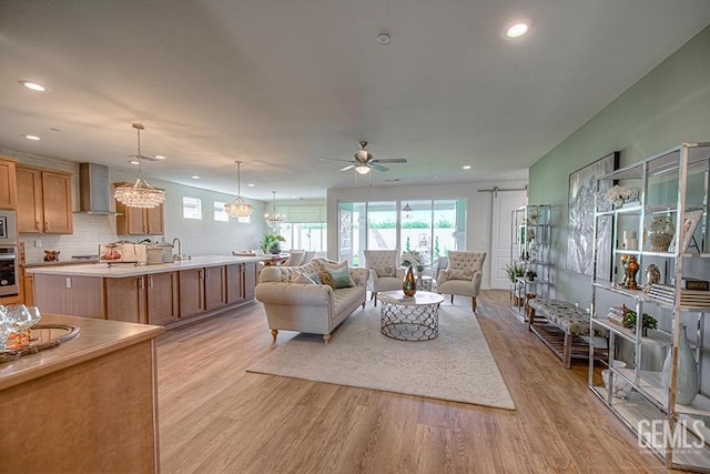 11022 Irontooth Ave, Bakersfield, CA 93311 - living area with light wood-style flooring, a ceiling fan, recessed lighting, and a chandelier