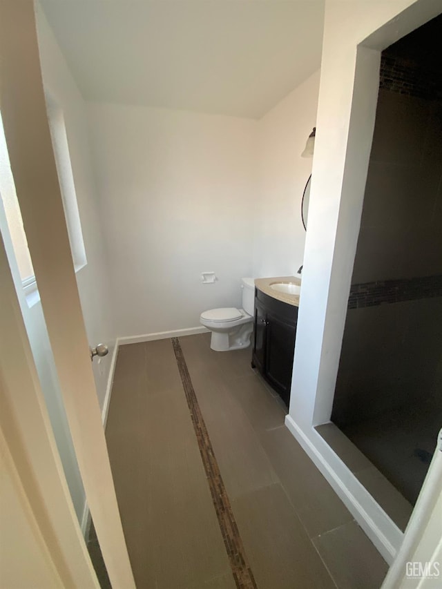 bathroom with tile patterned flooring, vanity, and toilet