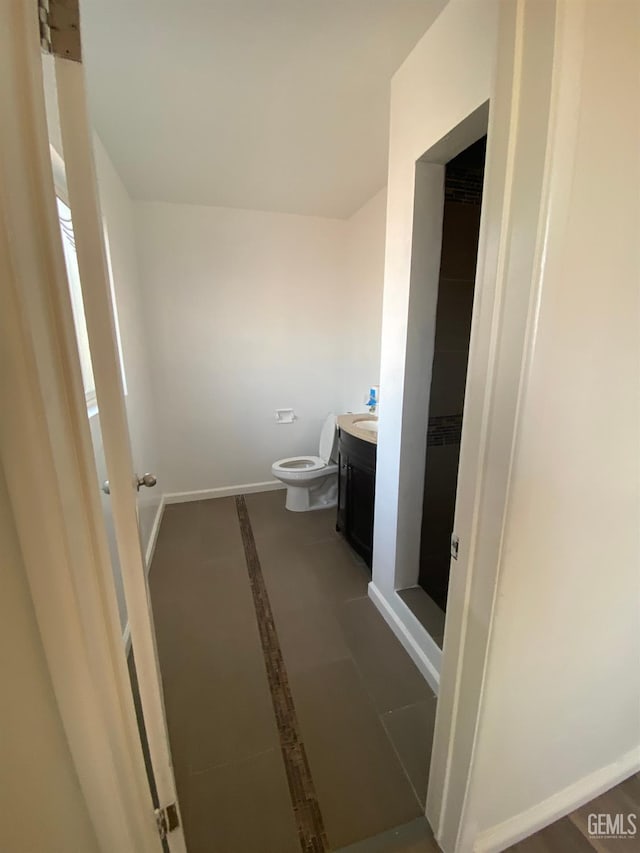 bathroom featuring tile patterned floors, vanity, and toilet