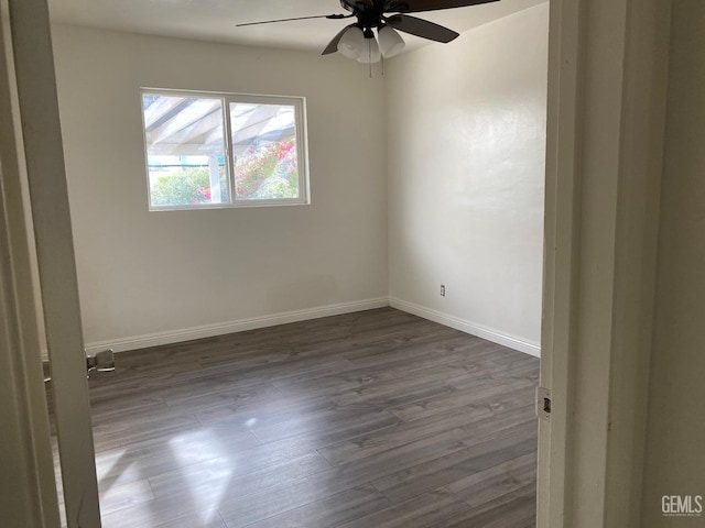 empty room featuring dark hardwood / wood-style floors and ceiling fan