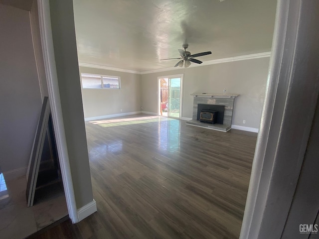 unfurnished living room with dark hardwood / wood-style flooring, ceiling fan, and ornamental molding