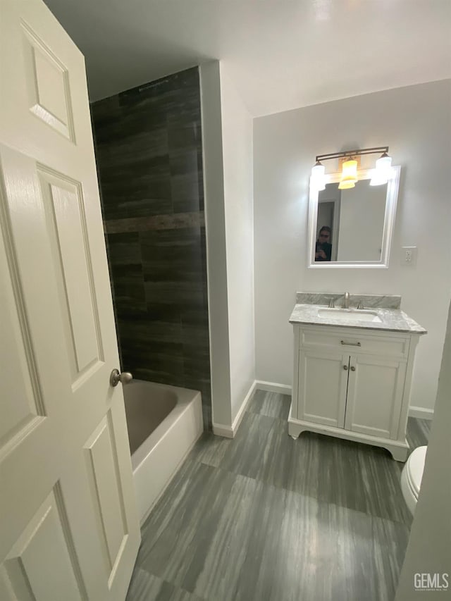 full bathroom featuring shower / washtub combination, vanity, and toilet